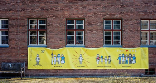 Yellow poster at a migratory centre in Kreuzberg, Berlin