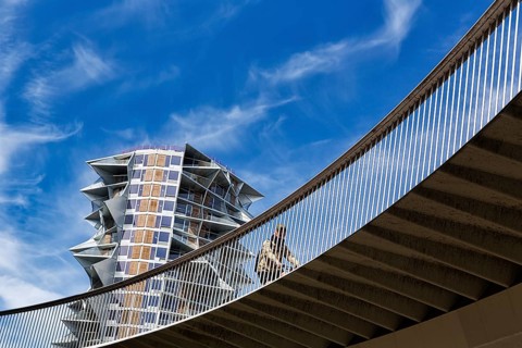 Cyclists on bridge at Kaktus Tower skyscraper, Cykelslangen bicycle bridge