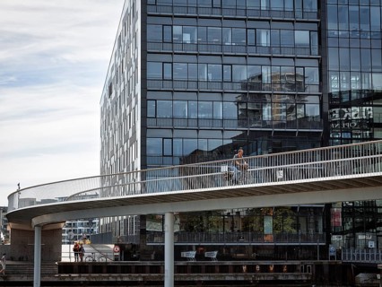 Cyclists on bridge over inner harbour basin, Cykelslangen bicycle bridge