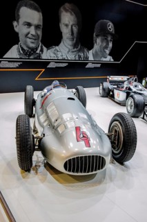 Historic Mercedes Silver Arrow racing car of Rudolf Caracciola, in the background photo from left Rudolf Caracciola
