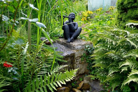 Black Garden Figurine with Flute by the Garden Stream