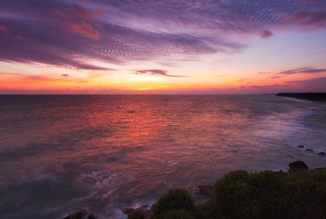 Ocean sunset on rocky coast. Varkala