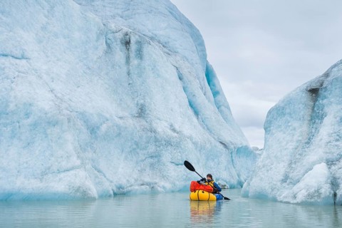 Woman with packraft at sea