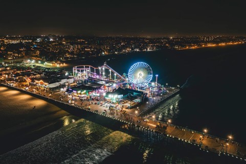 Circa November 2019: Santa Monica Pier at Night in super colourful lights from Aerial Drone perspective in Los Angeles