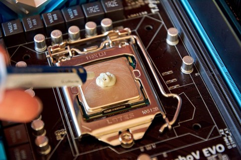 Applying thermal paste to the central processor of the motherboard close up