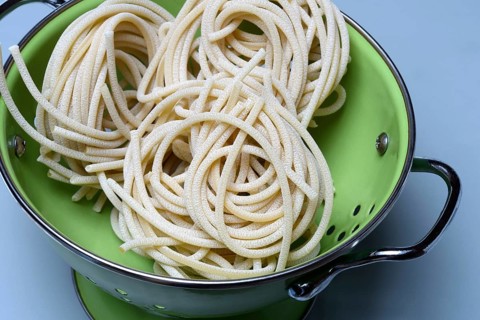 Pici pasta in kitchen colander
