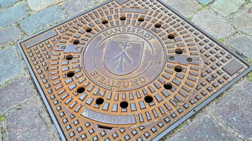 Manhole cover with coat of arms of the Hanseatic City of Stralsund. Mecklenburg-Western Pomerania