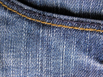Denim jeans as blue background. With trouser pocket shown in full image in the plane