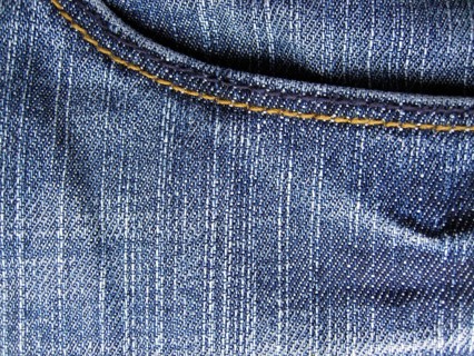 Denim jeans as blue background. With trouser pocket shown in full image in the plane