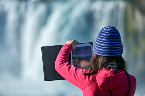 Young woman making panorama with tablet