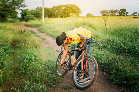 Man repairing his bike in the middle of the road