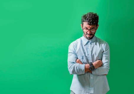 Angry and annoyed man with crossed arms isolated