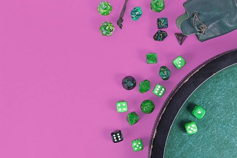 Different green roleplaying dices on purple background