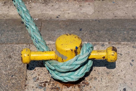 A boat tied with robe to bollard
