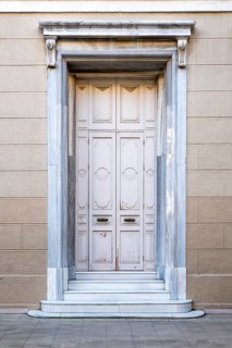 Closed old white wooden house door