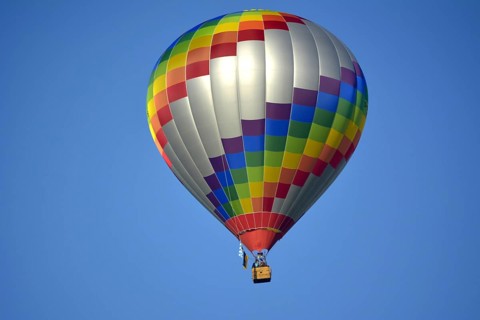 Beautiful colourful hot air balloon in the air with blue sky