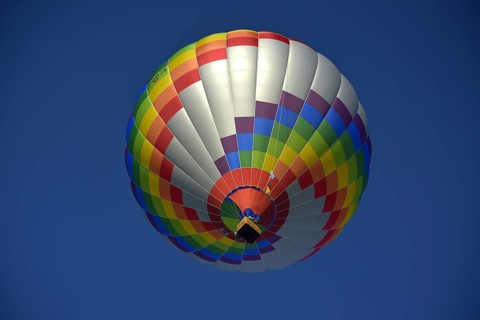 Beautiful colourful hot air balloon in the air with blue sky