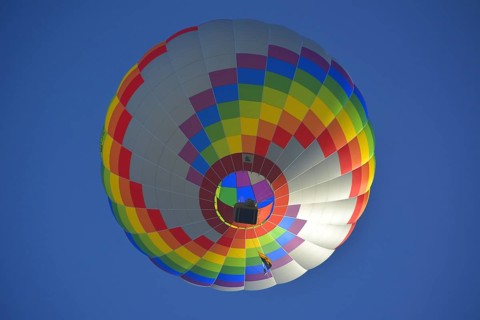 Beautiful colourful hot air balloon in the air with blue sky