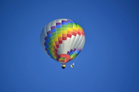 Beautiful colourful hot air balloon in the air with blue sky