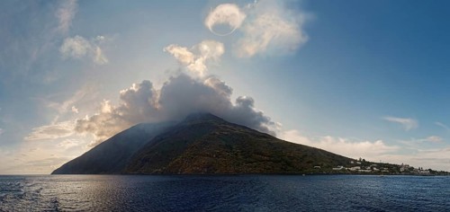 Stromboli volcano and island with the small fishing village of San Vincenzo with a circular smoke ring