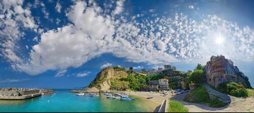Panorama of the small bay and beach of Pizzo below the church Chiesa del Carmine with small fishing boats under bizarre cloudy sky