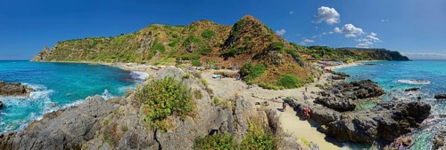Panorama at the sandy beach and bay Capo Vaticano with turquoise sea and bizarre sky