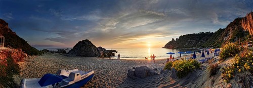 Panorama on the sandy beach and bay Capo Vaticano at sunset