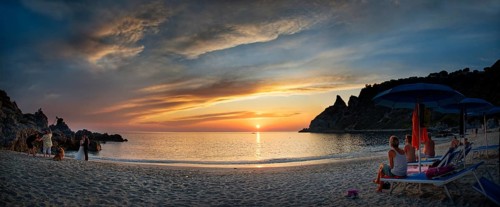 Panorama on the sandy beach and bay Capo Vaticano at sunset