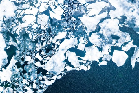 Droneview on a lake with floating ice sheet in the montain range Hemsedalfjell
