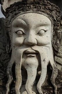 Wat Pho Chinese stone guardian face close up