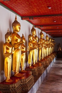 Standing golden Buddha statues. Wat Pho temple