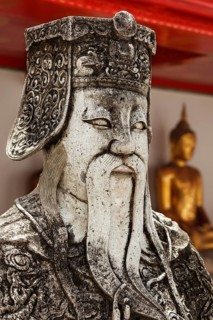 Wat Pho Chinese stone guardian face close up