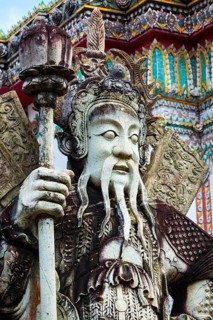 Chinese stone guardian statue close up in Wat Pho Buddhist Temple