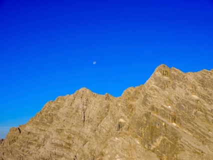 Upper part of the east face of the Watzmann with blue sky and full moon
