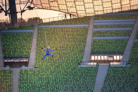 Woman swinging on a zip line above the Olympic Stadium