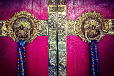 Vintage retro hipster style travel image of door handles on gates of Ki monastry. Spiti Valley