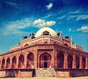 Vintage retro hipster style travel image of Humayun's Tomb with overlaid grunge texture. Delhi