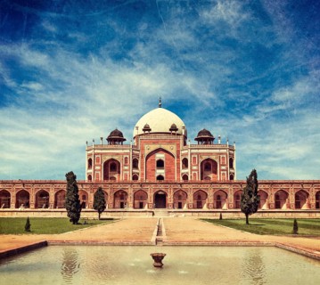Vintage retro hipster style travel image of Humayun's Tomb with overlaid grunge texture. Delhi
