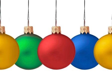 Row pf hanging Christmas baubles isolated on white background