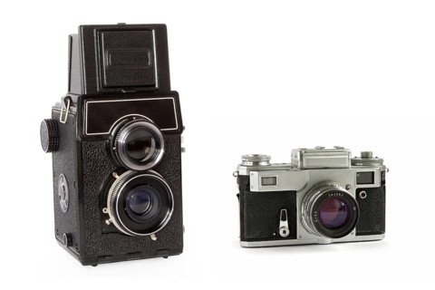 Old rangefinder and twin-lens reflex large format film cameras isolated on white background