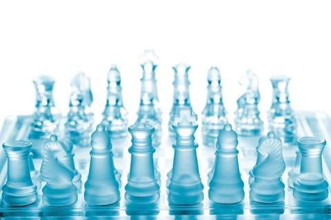Glass chess on chessboard