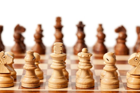 Wooden chess pieces on chessboard. Selective focus