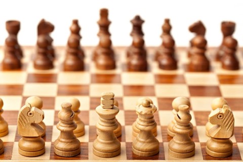 Wooden chess pieces on chessboard. Selective focus