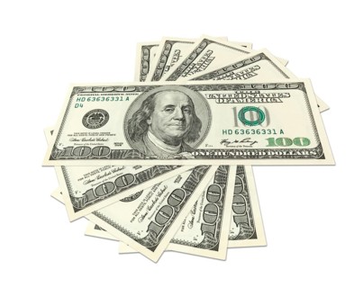 Hundreds of dollars spread on white background