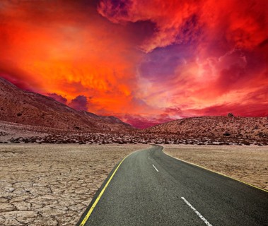 Road in desert on sunset
