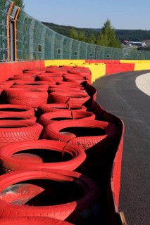 Safety measure for car racing Impact protection red yellow coloured tyre piles next to gravel bed in turn 8 of racetrack for motorsport