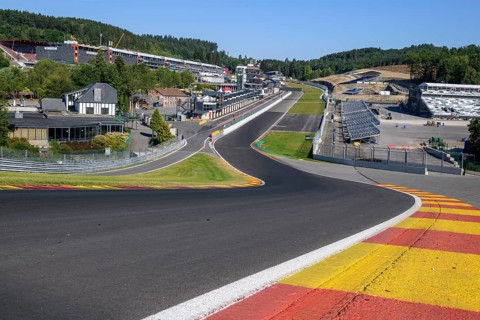 View from 40 metres high hilltop above the steep Raidillon driveway in the foreground to the dangerous Eau Rouge bend in the background of the Spa Francorchamps race track without racing cars