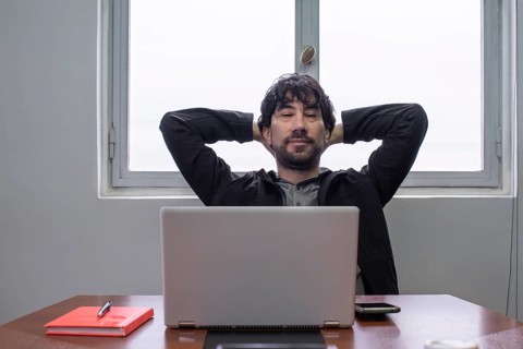 Relaxed businessman at the work desk