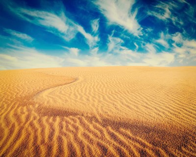 Vintage retro effect filtered hipster style image of white sand dunes on sunrise
