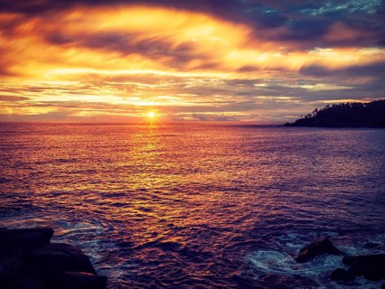 Vintage retro effect filtered hipster style image of romantic ocean sunset with dramatic sky. Mirissa